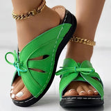 Chaussons à talons compensés plats avec nœud ajouré