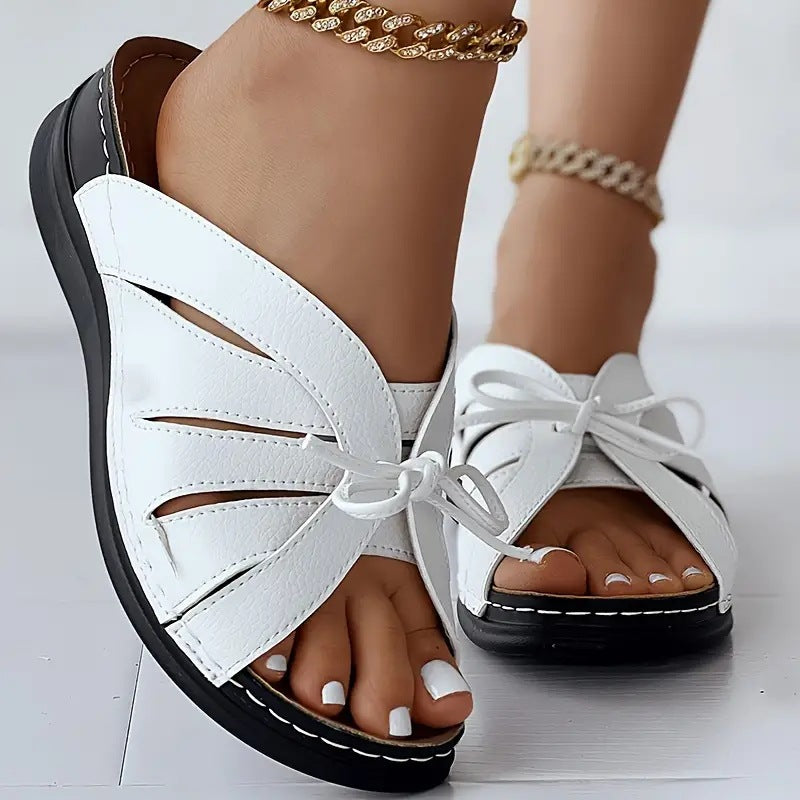 Chaussons à talons compensés plats avec nœud ajouré