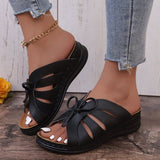 Chaussons à talons compensés plats avec nœud ajouré