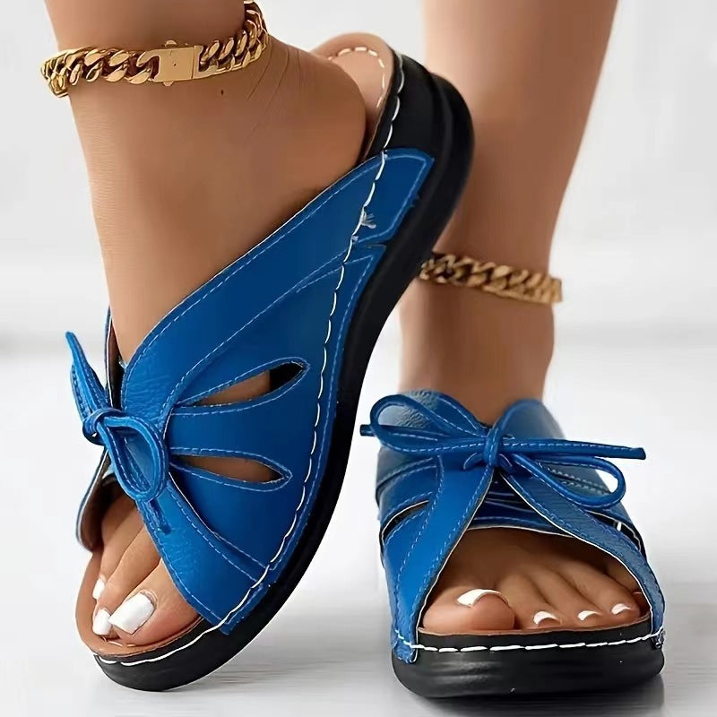 Chaussons à talons compensés plats avec nœud ajouré